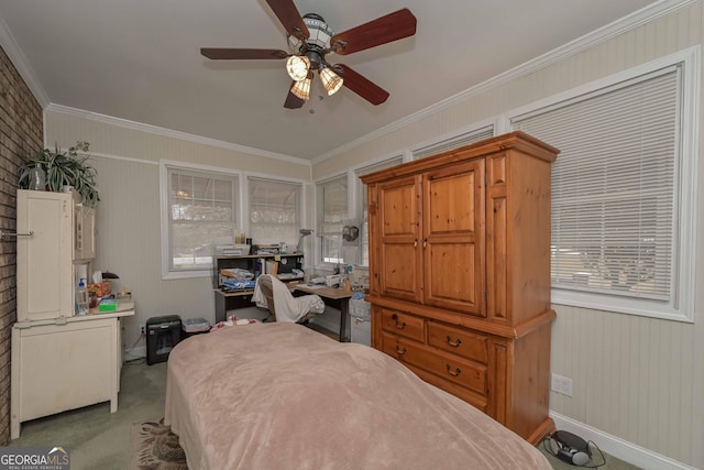 carpeted bedroom with ceiling fan and crown molding