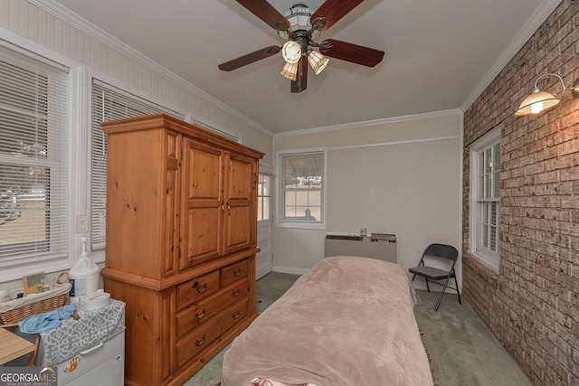 carpeted bedroom with ceiling fan, ornamental molding, and brick wall