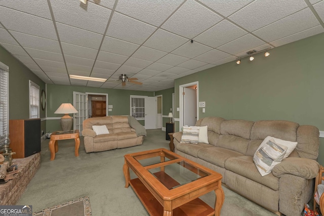 living room with carpet floors, ceiling fan, and a paneled ceiling