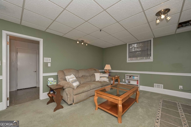 carpeted living room featuring a paneled ceiling