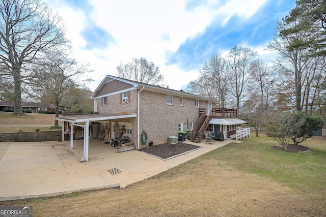 back of house featuring a deck and a yard