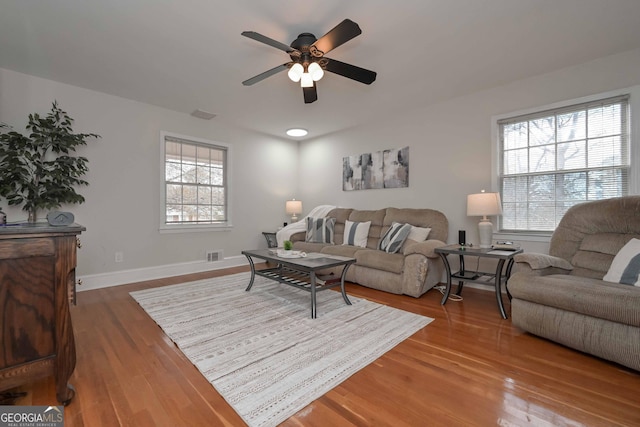 living room with ceiling fan and hardwood / wood-style floors