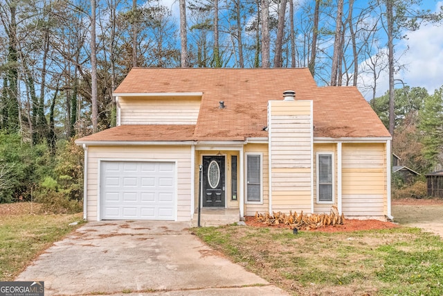 view of front facade with a garage and a front lawn