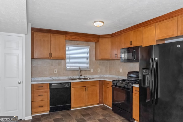 kitchen featuring decorative backsplash, a textured ceiling, sink, and black appliances