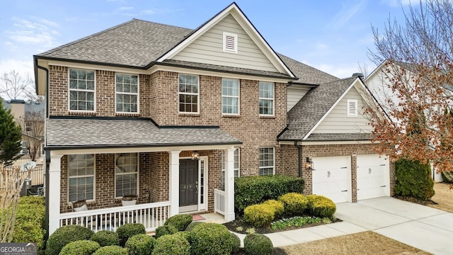 view of front property with covered porch and a garage