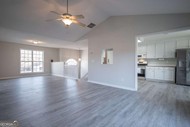 unfurnished living room with ceiling fan, light wood-type flooring, and high vaulted ceiling