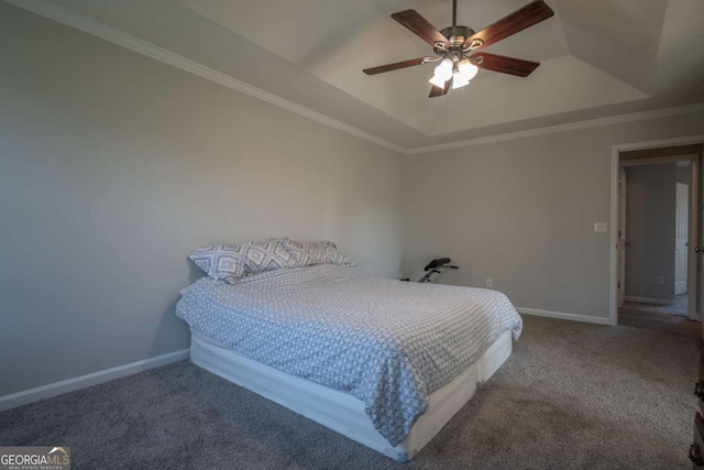 carpeted bedroom with a raised ceiling, ceiling fan, and ornamental molding