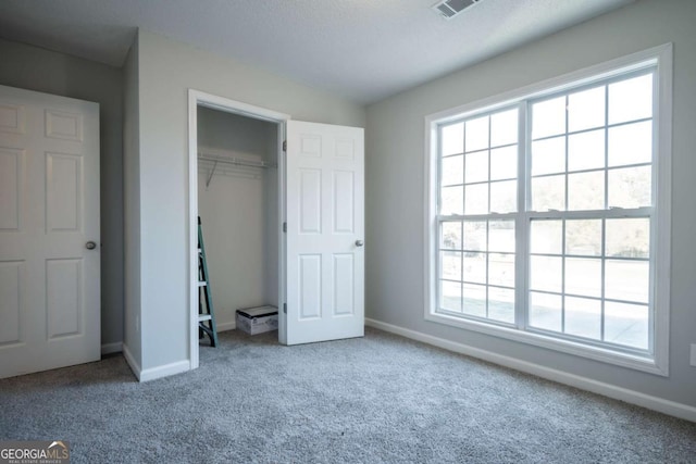 unfurnished bedroom featuring carpet floors and a closet