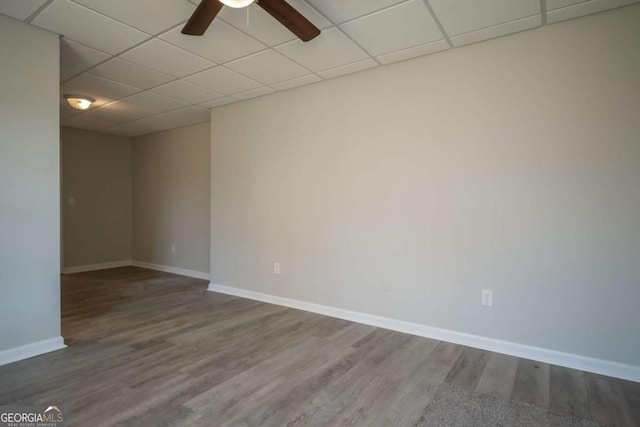 unfurnished room featuring a paneled ceiling, ceiling fan, and hardwood / wood-style floors