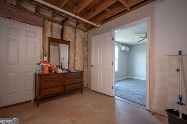 interior space featuring ceiling fan and a wall mounted air conditioner