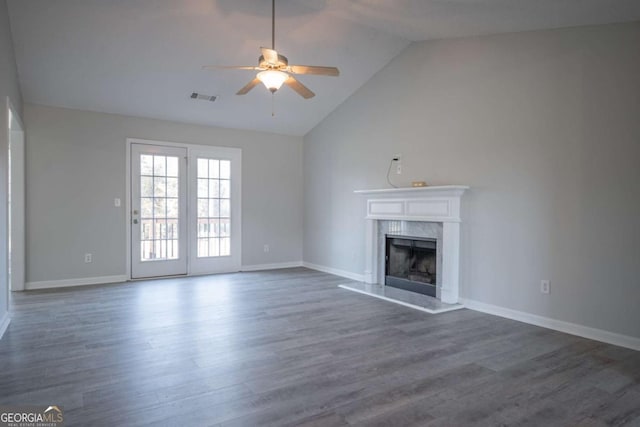 unfurnished living room with a fireplace, high vaulted ceiling, ceiling fan, and dark wood-type flooring