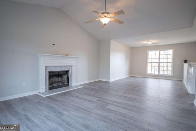 unfurnished living room featuring lofted ceiling, ceiling fan, and wood-type flooring