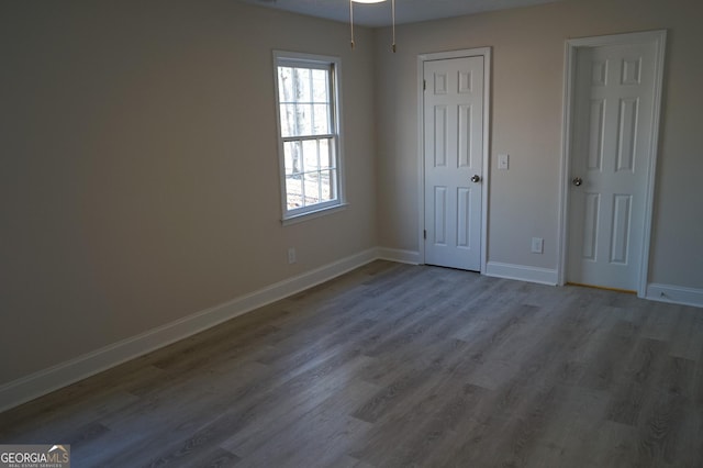 unfurnished bedroom with hardwood / wood-style flooring