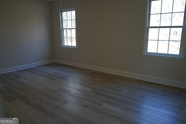 spare room featuring dark hardwood / wood-style flooring