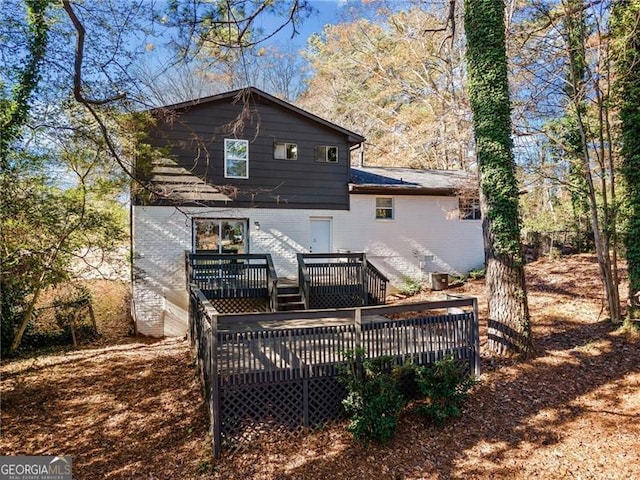 back of house with a wooden deck