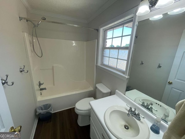 full bathroom featuring hardwood / wood-style floors,  shower combination, toilet, vanity, and ornamental molding