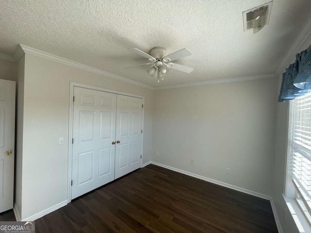 unfurnished bedroom featuring a closet, ceiling fan, ornamental molding, and dark hardwood / wood-style floors