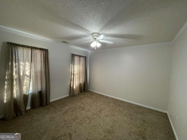 carpeted spare room with crown molding, a textured ceiling, and ceiling fan