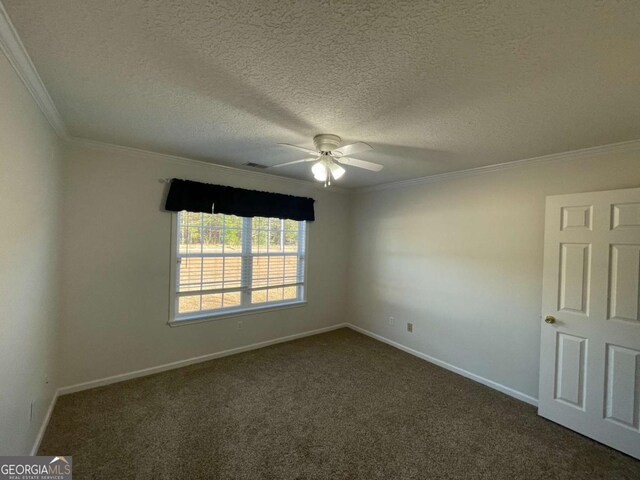 unfurnished room with ceiling fan, ornamental molding, a textured ceiling, and dark colored carpet