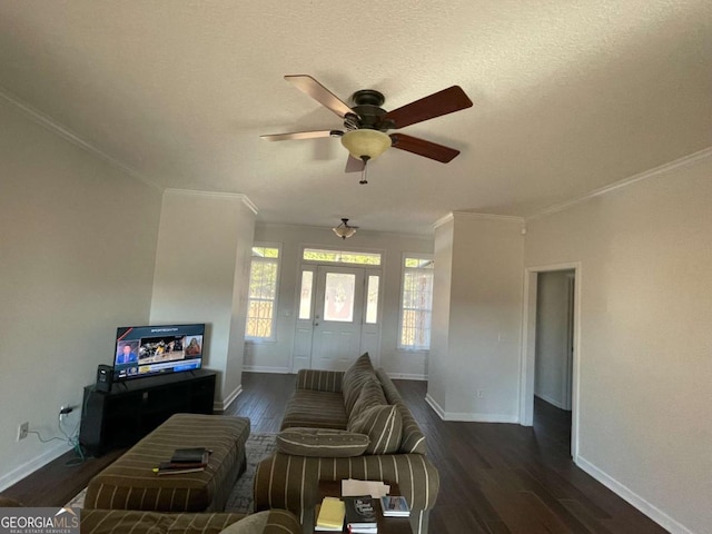 living room featuring a textured ceiling, dark hardwood / wood-style flooring, ceiling fan, and crown molding