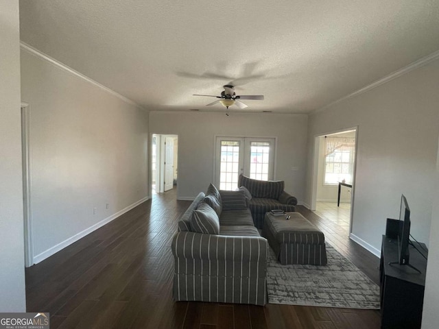 living room featuring ceiling fan, crown molding, dark hardwood / wood-style floors, and a textured ceiling