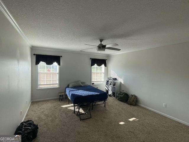 carpeted bedroom featuring a textured ceiling, ornamental molding, and ceiling fan