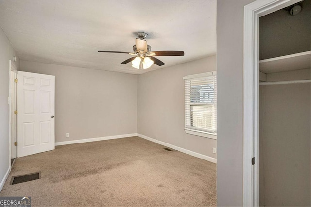 unfurnished bedroom featuring carpet floors, a closet, and ceiling fan