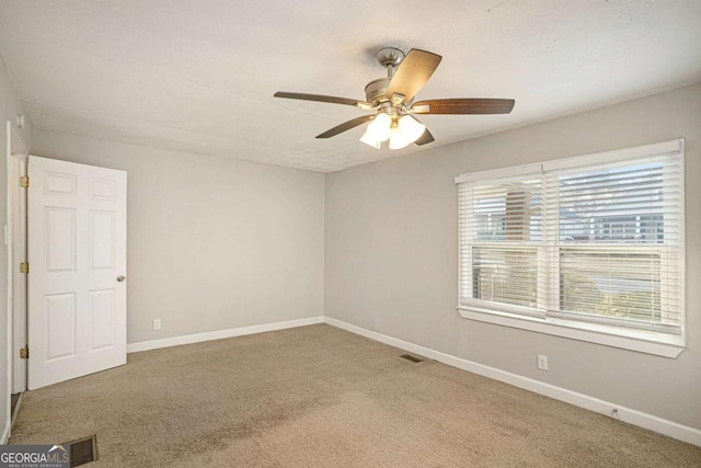 carpeted empty room featuring ceiling fan