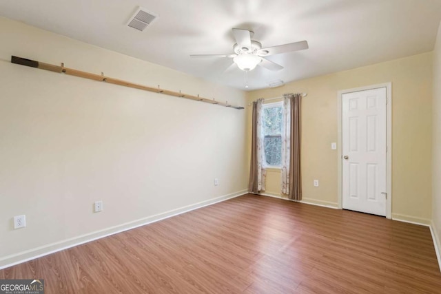 unfurnished room featuring hardwood / wood-style floors and ceiling fan