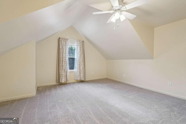 bonus room with ceiling fan, light colored carpet, and lofted ceiling