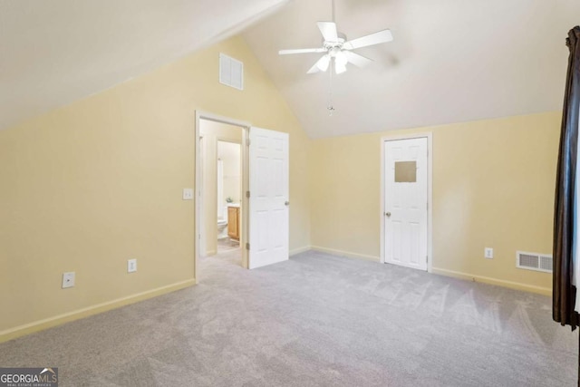 unfurnished bedroom featuring ceiling fan, light colored carpet, and vaulted ceiling