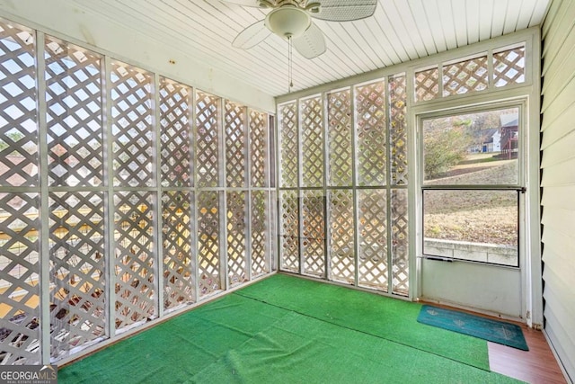 unfurnished sunroom featuring ceiling fan and wooden ceiling