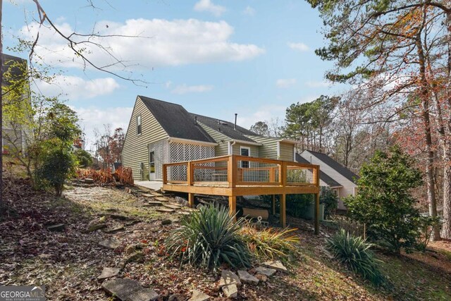 back of house featuring a wooden deck