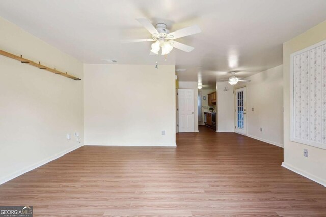 unfurnished living room featuring light hardwood / wood-style floors and ceiling fan