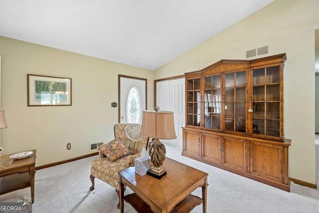 living room featuring light carpet and vaulted ceiling