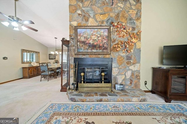 living room featuring ceiling fan with notable chandelier, a stone fireplace, light carpet, and high vaulted ceiling