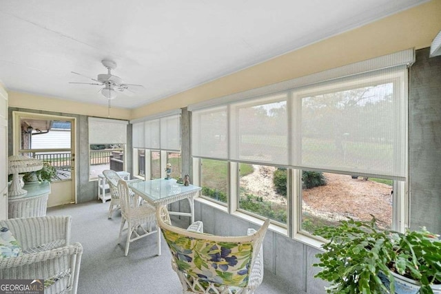 sunroom / solarium featuring ceiling fan