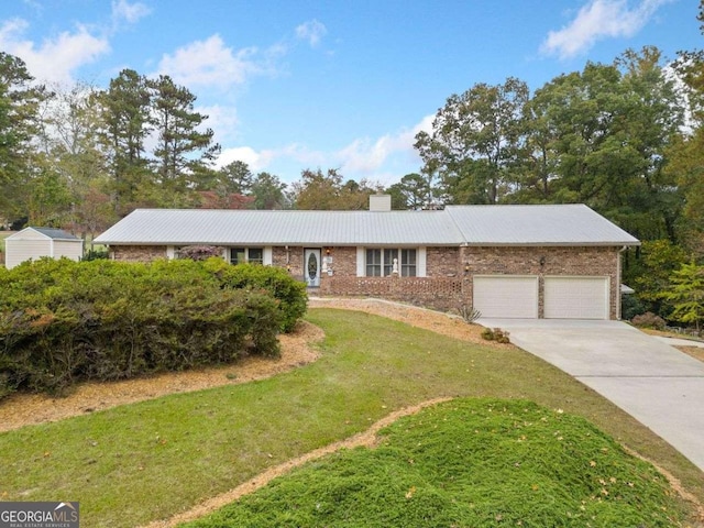 single story home featuring a front yard and a garage