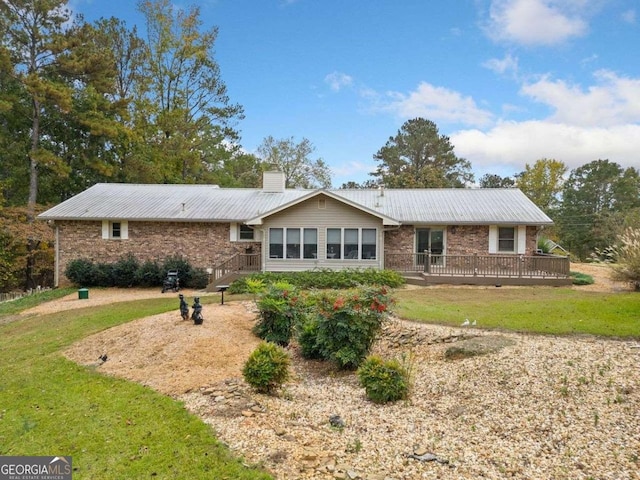 rear view of house featuring a lawn