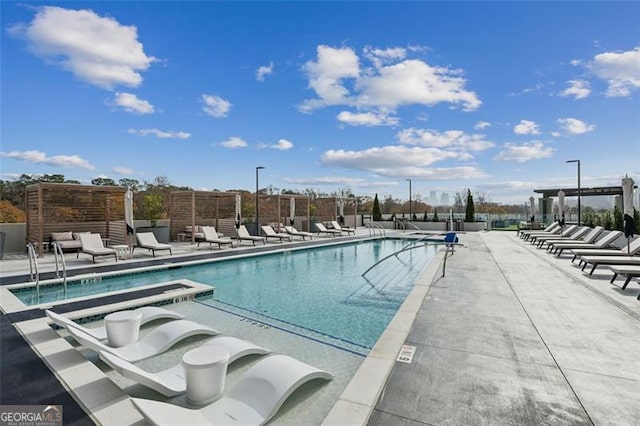 view of pool featuring a patio area and a hot tub