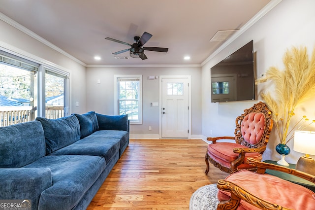 living room with crown molding, light hardwood / wood-style flooring, and ceiling fan