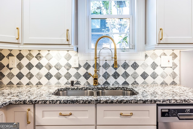 kitchen featuring light stone countertops and white cabinetry