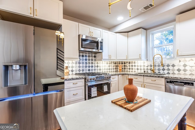 kitchen with white cabinetry, sink, and appliances with stainless steel finishes