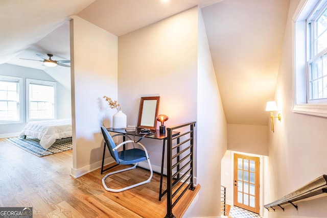 interior space with hardwood / wood-style flooring, ceiling fan, and lofted ceiling