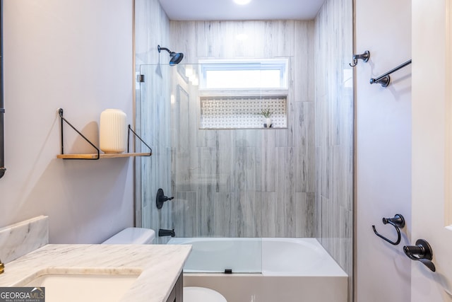 full bathroom featuring vanity, toilet, and bath / shower combo with glass door