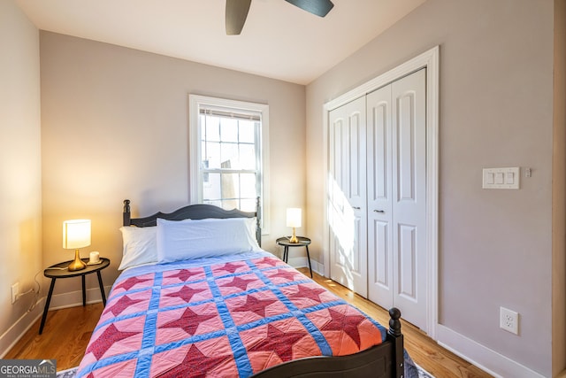 bedroom with ceiling fan, a closet, and wood-type flooring