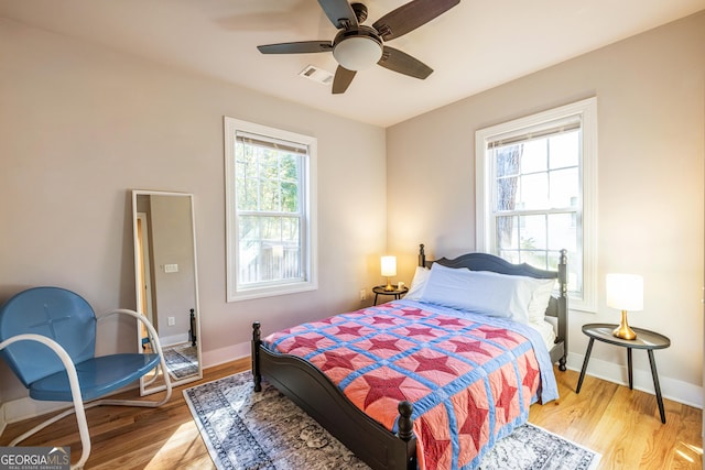 bedroom with light hardwood / wood-style flooring and ceiling fan