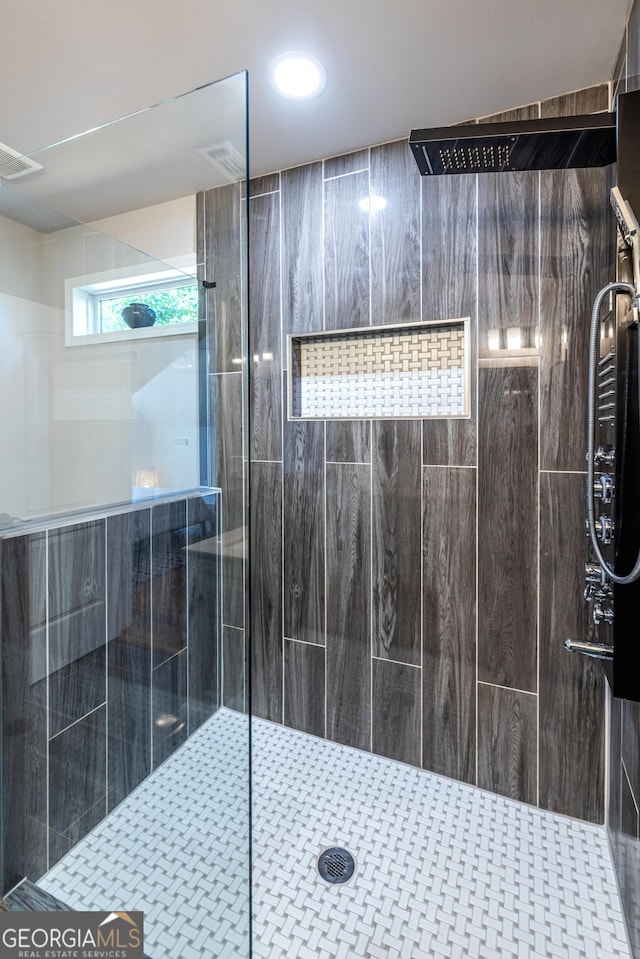 bathroom with a tile shower