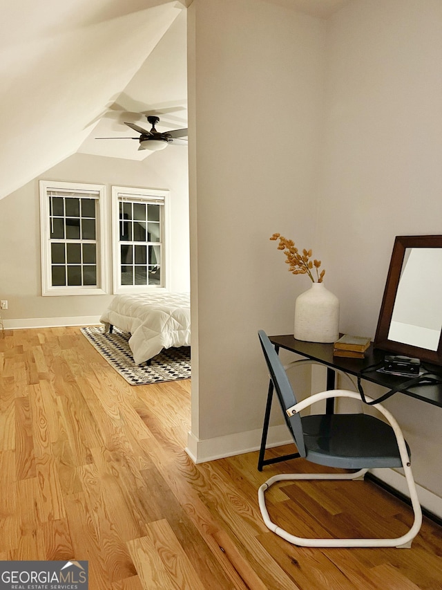 bedroom with light wood-type flooring, vaulted ceiling, and ceiling fan