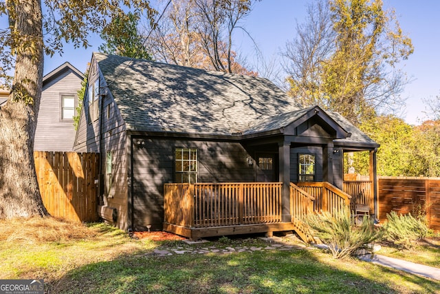 view of front of home featuring a deck and a front yard